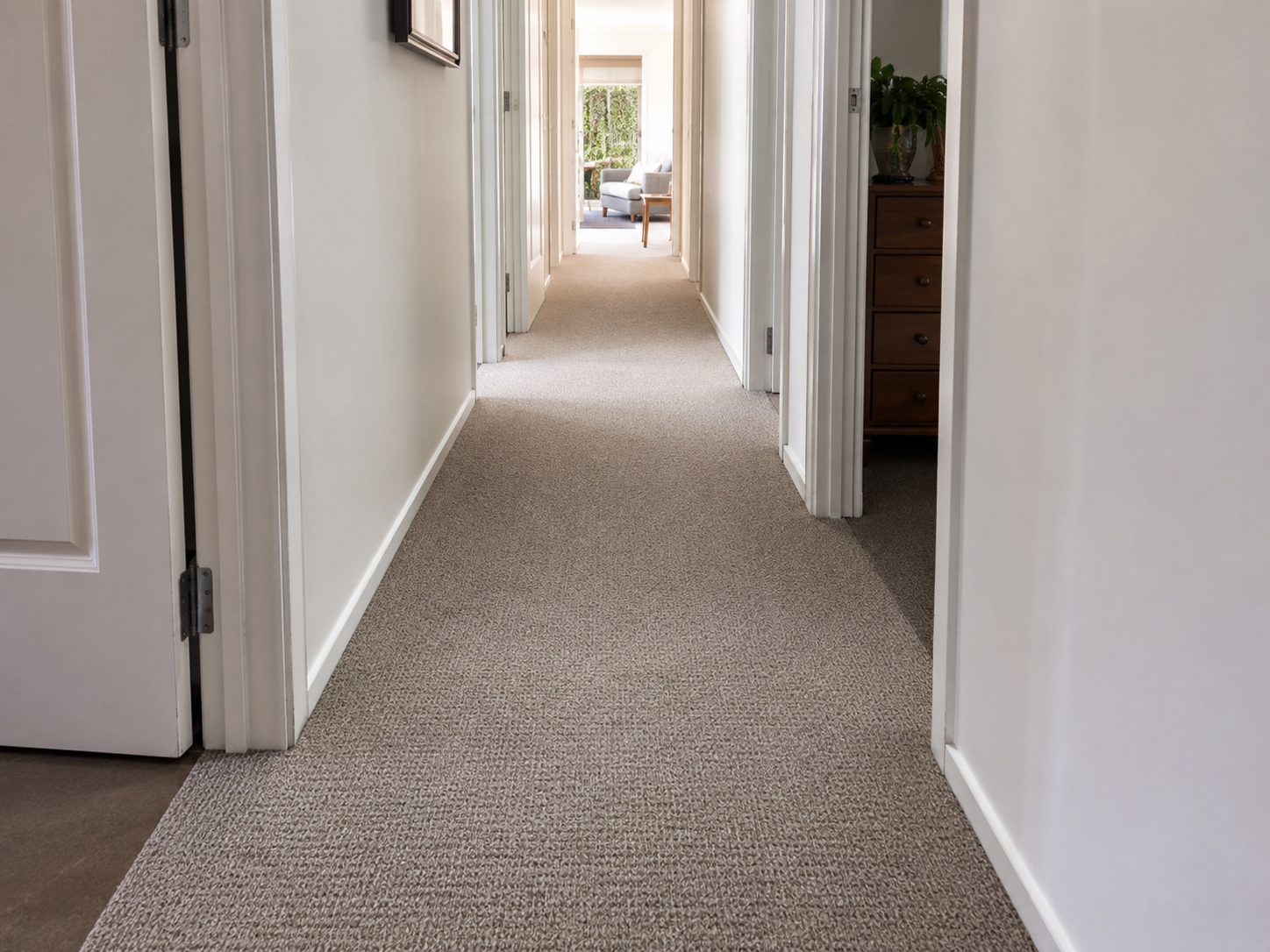 Main hallway with practical neutral carpet